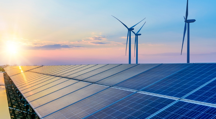 Solar panels and wind turbines at sunset