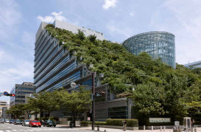 A green building covered in terraced gardens and vegetation