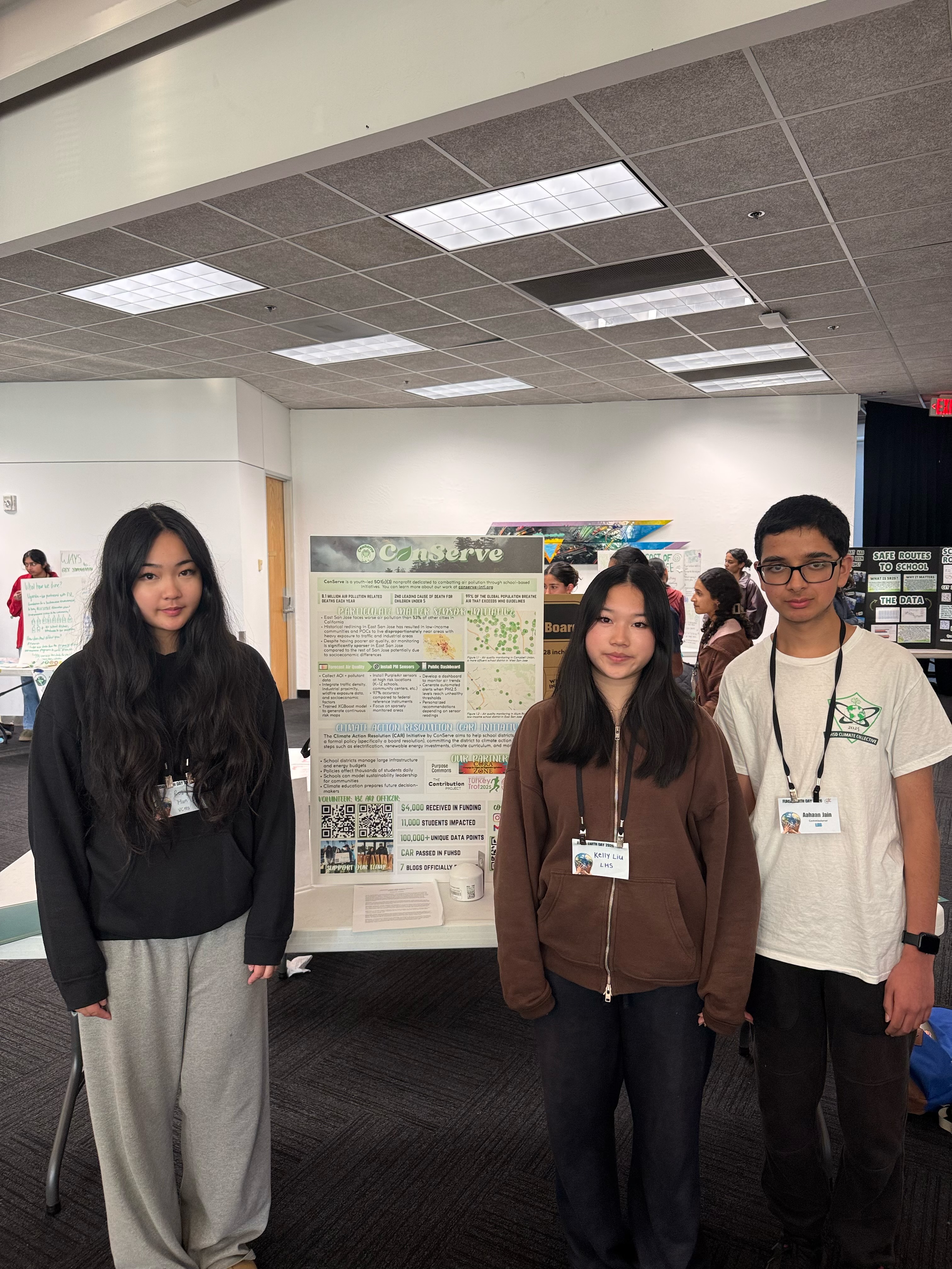 ConServe students presenting an air quality monitoring display at an Earth Day event